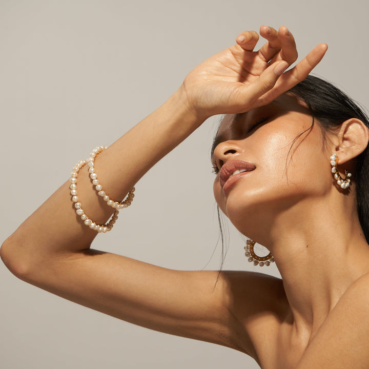 Salita Matthews model wearing the Gold Sofia Bangle and earrings.