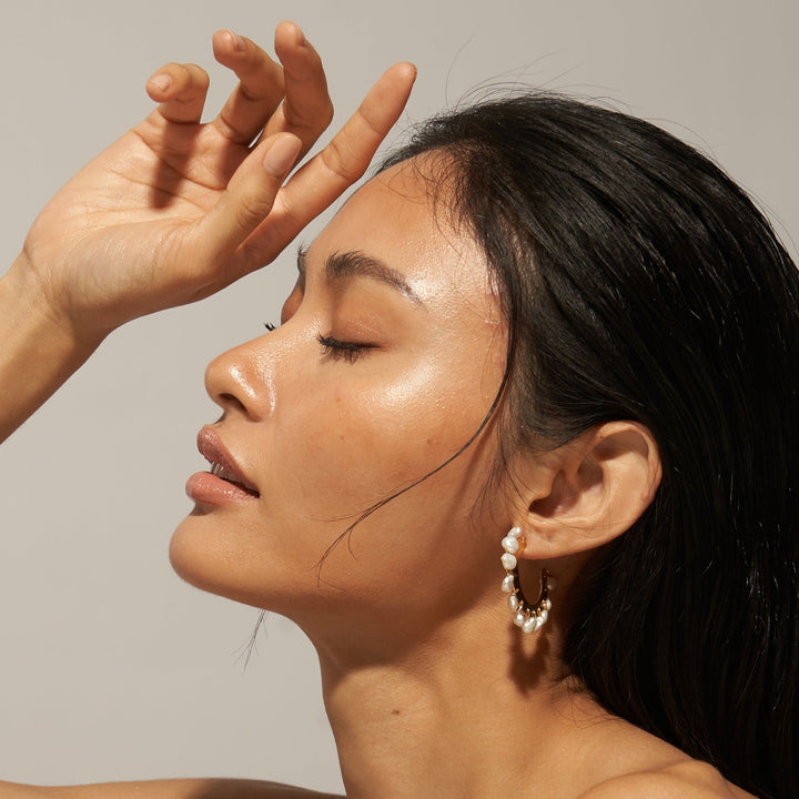 Salita Matthews model wearing the Iesha gold half hoop pearl earrings.