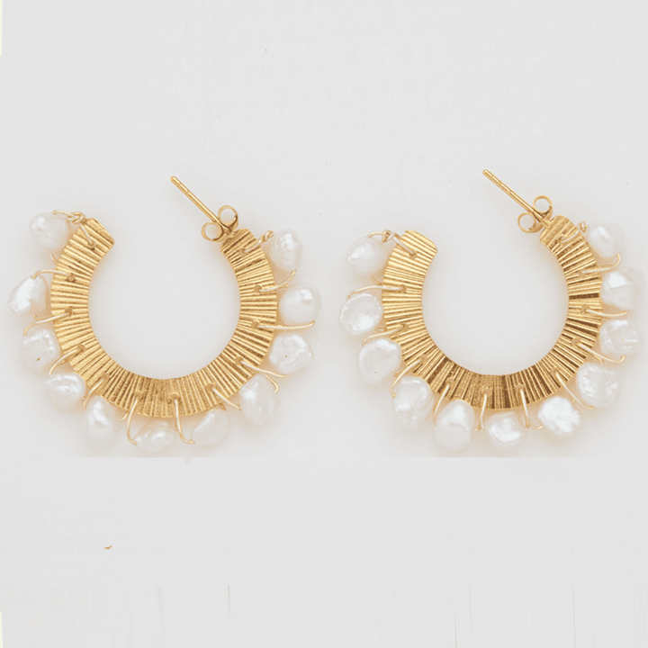 The Iesha gold half hoop pearl earrings.